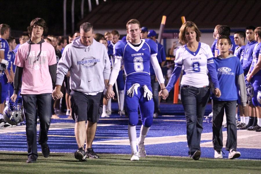 Ryan walking out with his family on senior night