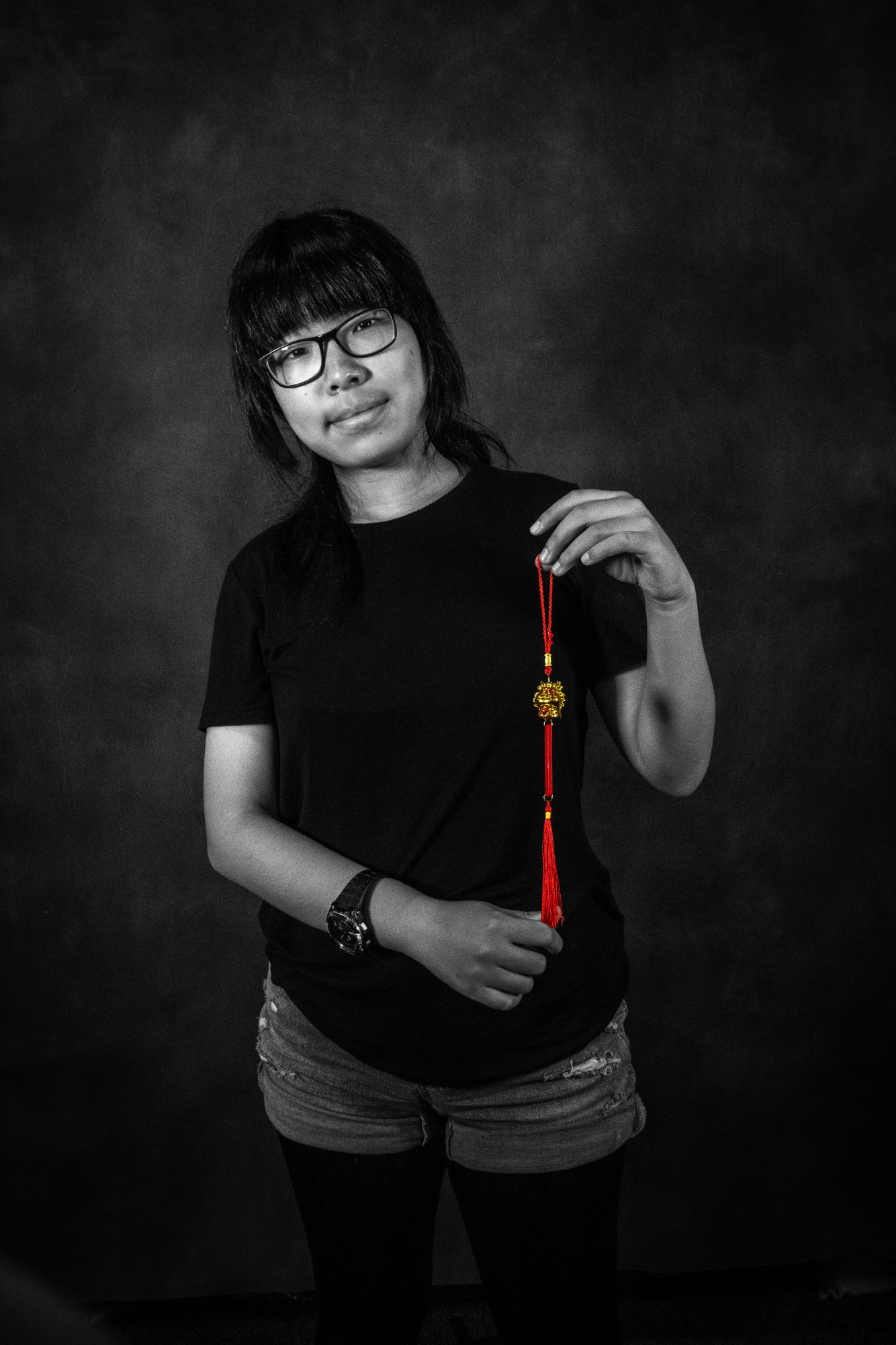 Jinyi Zhou holds a special pendant from China before she moved