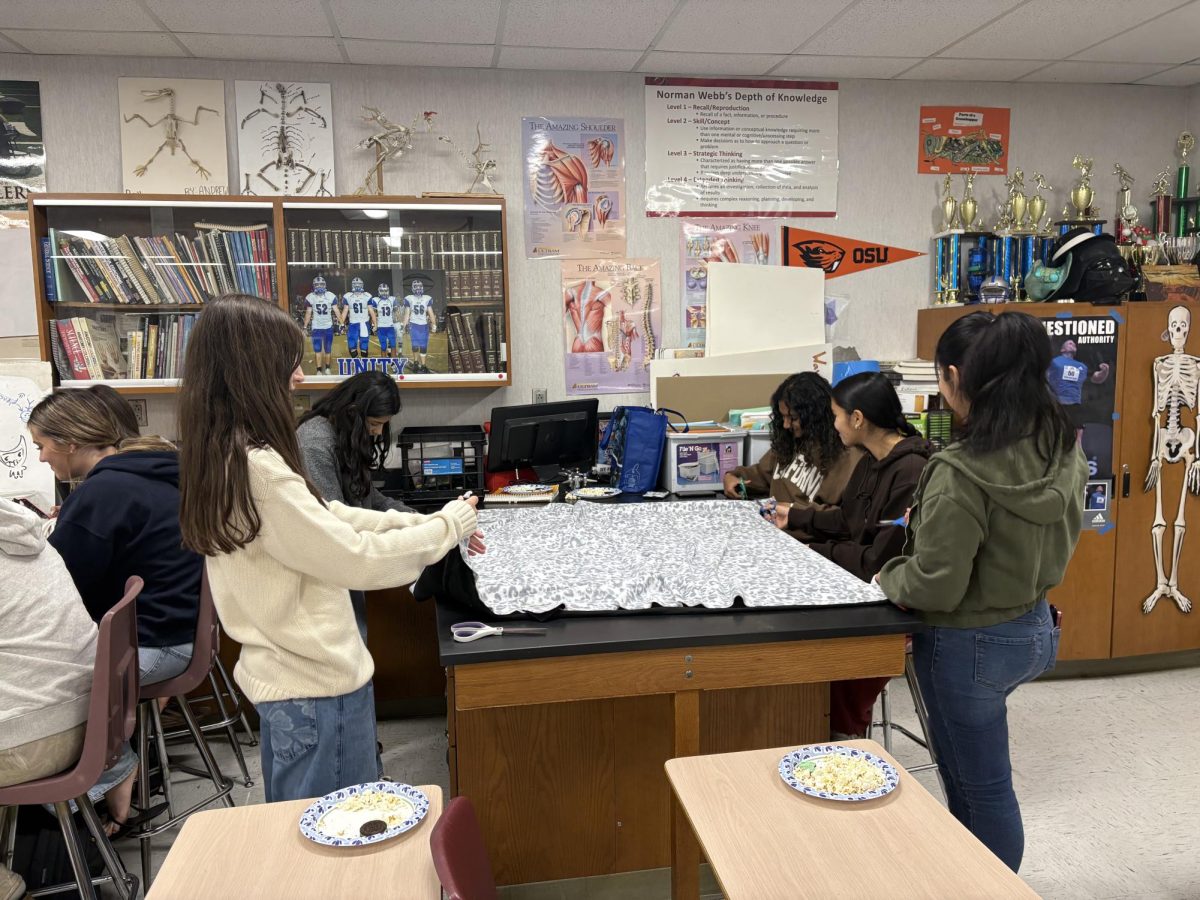 Medical club members making tied blankets to donate to local hospitals.
